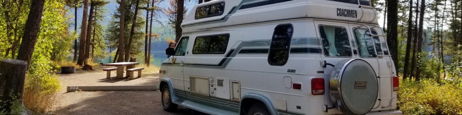 Jimmy photo-bombing our campervan, Dot, at our campsite in Holland Lake
